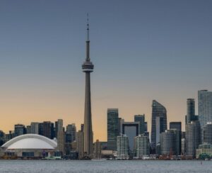 Toronto skyline at dusk, including the CN Tower, seen across the harbour